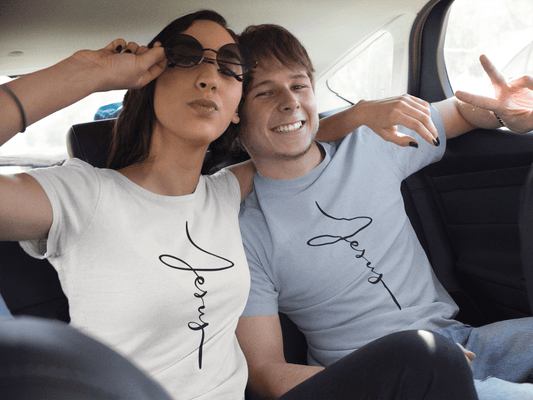 jesus cursive cross t-shirt in white on a happy woman and blue on a happy man