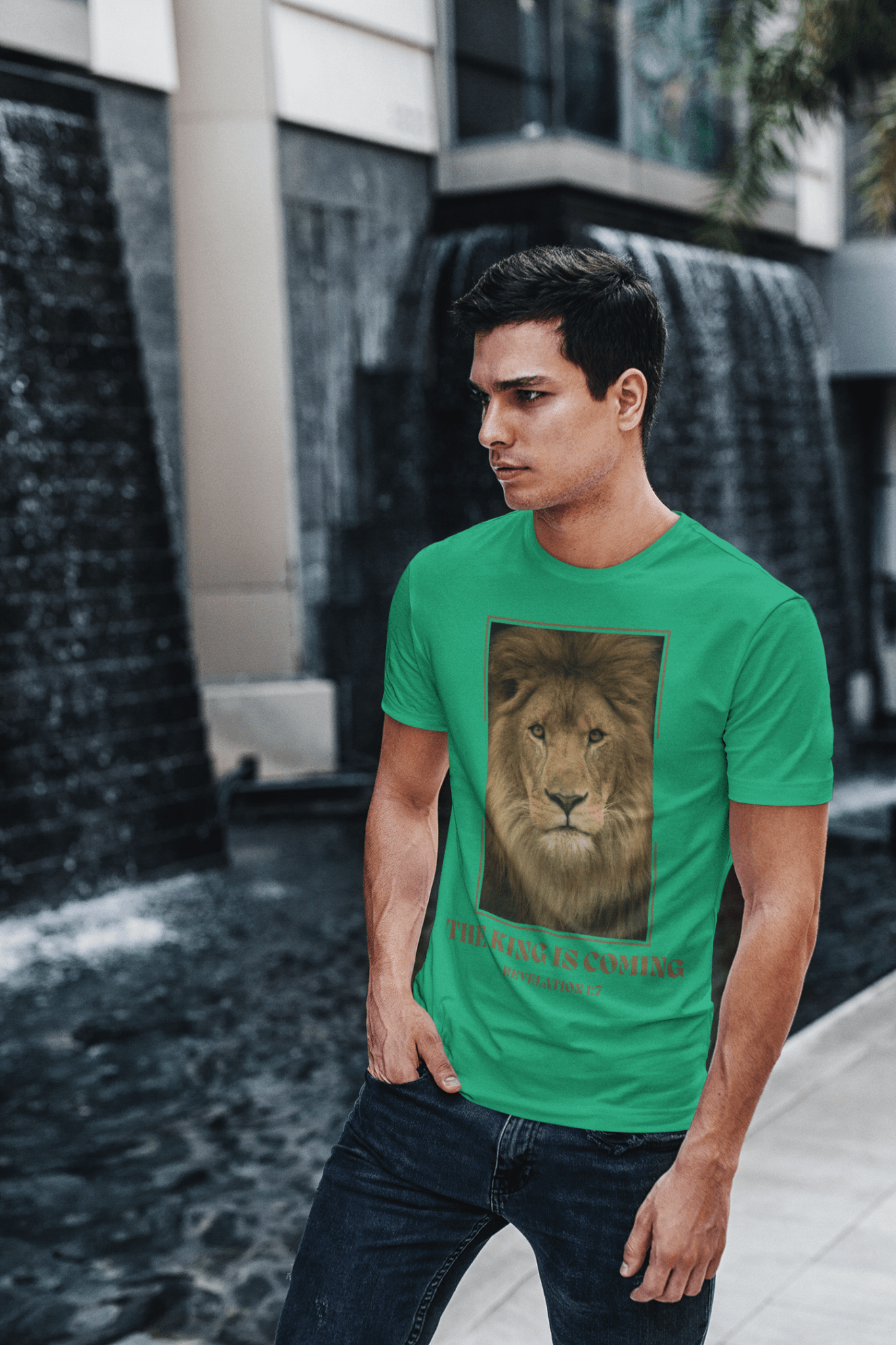The King Is Coming T-Shirt - Lion Revelation Christian Tee on eastern european man in front of waterfall